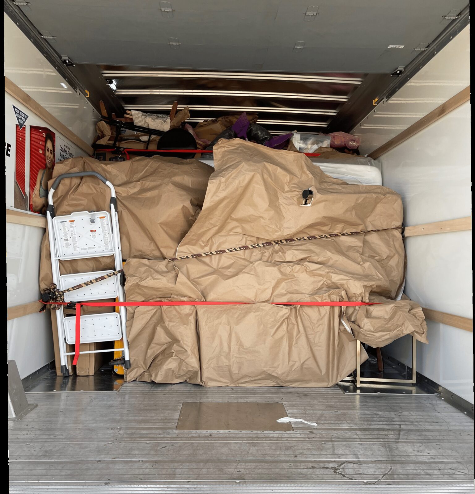Furniture wrapped in protective paper and loaded inside the moving truck
