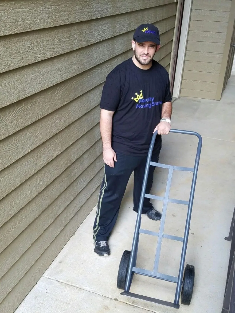 Royalty Moving crew member with a branded hand truck, ready for a Cary move