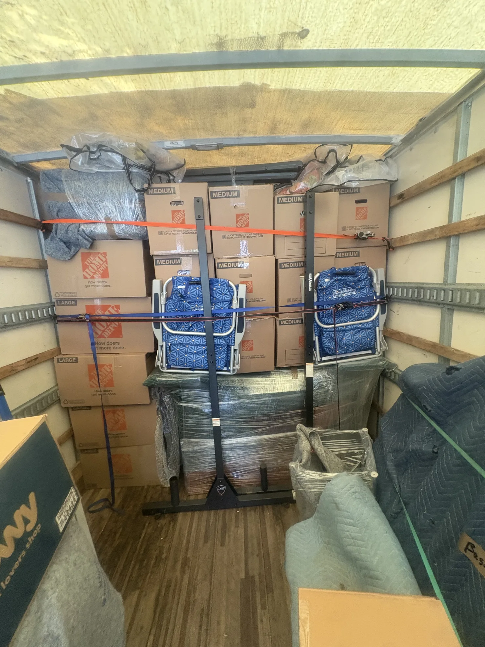 Wrapped furniture loaded carefully inside a Royalty Moving truck