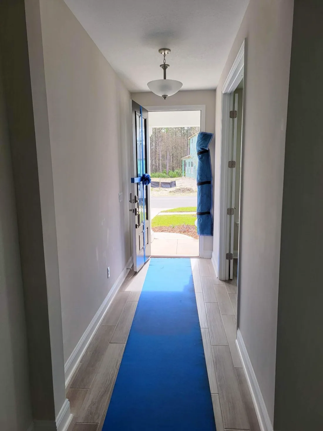 Blue floor runner protecting a home during a Cary move